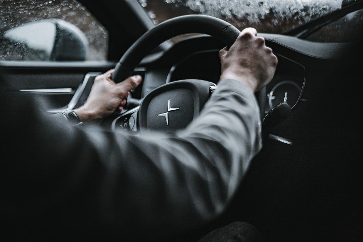 Close-up of hands on the steering wheel in a Polestar.