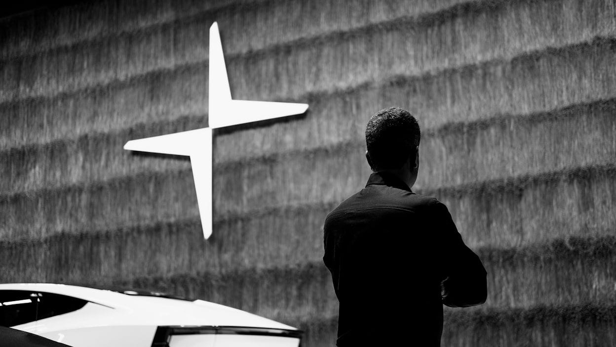 Chetan Kotur photographed in black and white, standing in front of a wall with the Polestar logo.