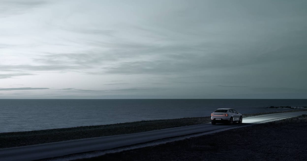 Polestar 2  rear view driving next to the sea