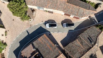 Aerial view of 2 Polestar 3s in remote Spanish village.