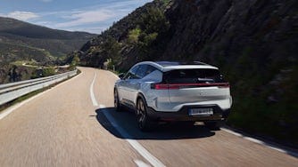 Polestar 3 in Snow color driving on a winding road in Spain