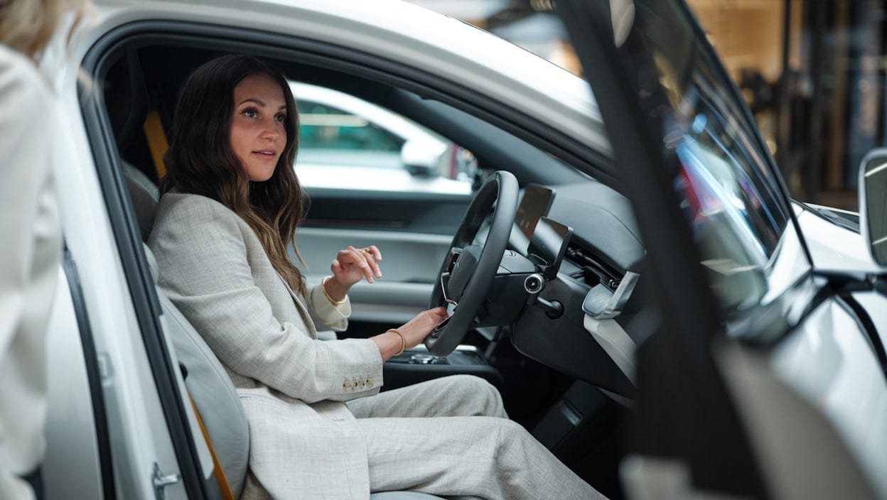 Alicia Vikander sitting in a Polestar car