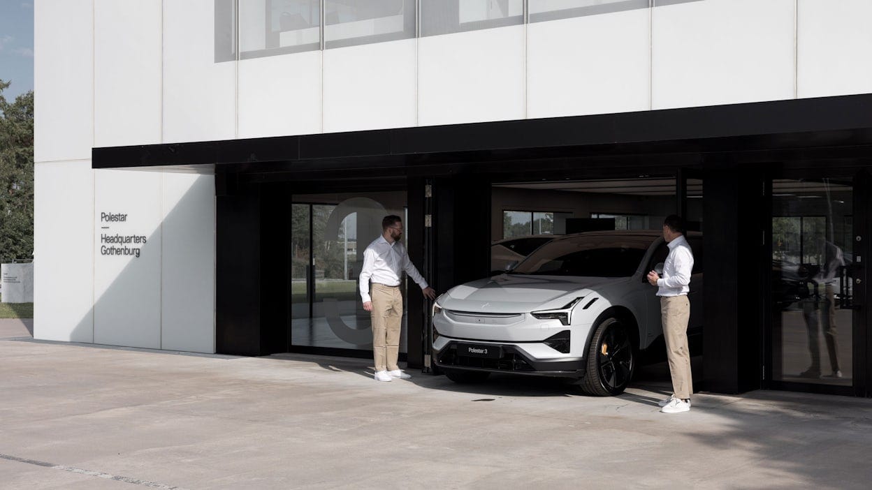 A Polestar 3 driving out from the Polestar HQ building