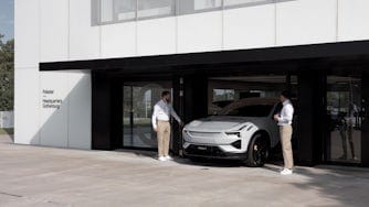 A Polestar 3 driving out from the Polestar HQ building