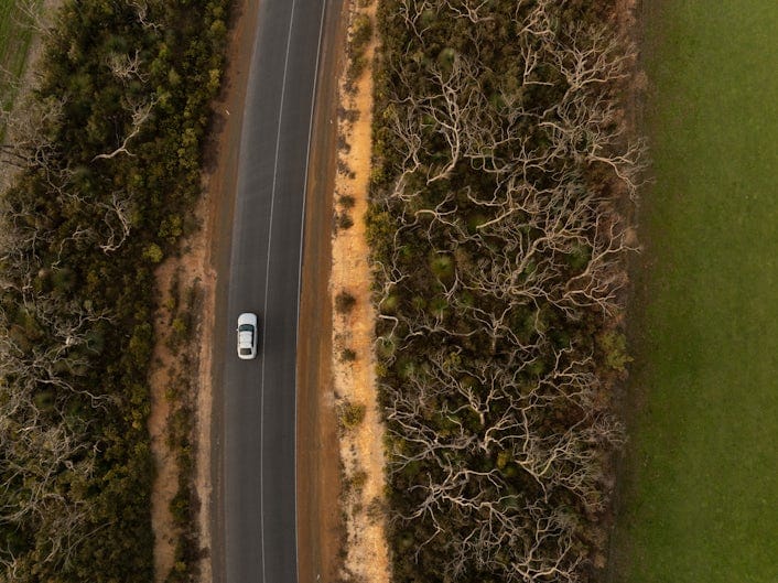 A bird's eye view of Stan's Polestar 2 driving the winding roads of Kangaroo Island