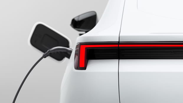 Close up of white Polestar rear end light left side charger plugged in