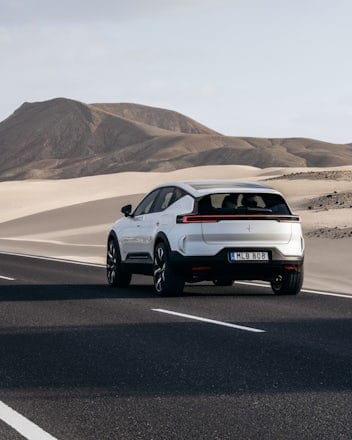 White Polestar 3 driving on a road in the desert.