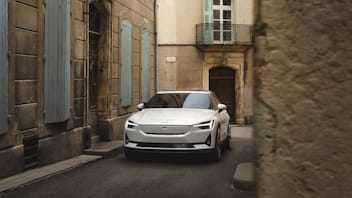 Polestar 2 pictured from the front in a narrow French street