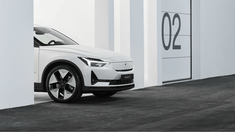 A white Polestar 2 standing in a garage.